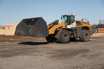 yellow industrial bulldozer at sawmill