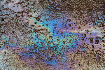 Oil slick on asphalt texture background