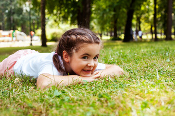 Naklejka na ściany i meble little cute caucasian girl playing cheerful in green park at summer, lifestyle people concept