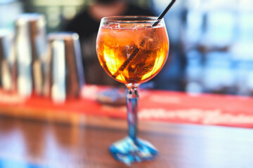 Row line of red colored negroni and spritz aperitif alcohol cocktails on a party of alcohol setting on catering banquet table, vodka, and others on decorated catering table event with bartender