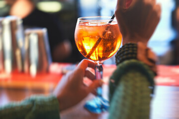 Row line of red colored negroni and spritz aperitif alcohol cocktails on a party of alcohol setting on catering banquet table, vodka, and others on decorated catering table event with bartender