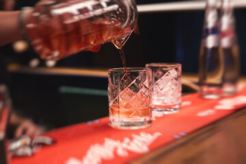 Row line of red colored negroni and spritz aperitif alcohol cocktails on a party of alcohol setting...