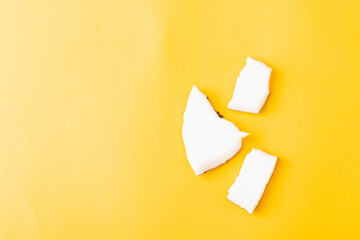 Happy coconuts day concept, fresh coconut group pieces slices, studio shot isolated on yellow background