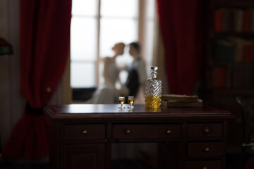 A realistic dollhouse living room with furniture and window at night. Artwork table decoration with handmade realistic dollhouse.