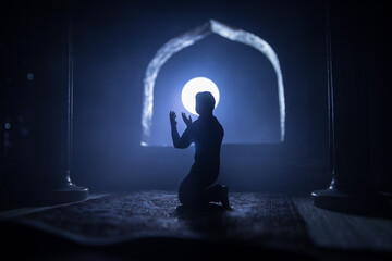 A realistic Arabian interior miniature with window and columns. Silhouette of muslim praying on...
