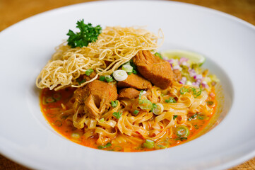 thai style chicken or duck red coconut curry noodle soup  with crispy noodle Khao Soi 