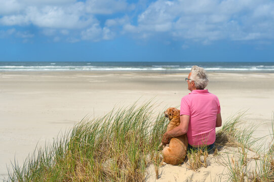 Man with dog at the beach