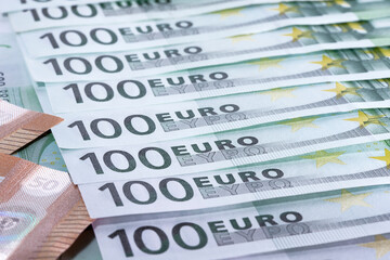 Heap of green houndred euro banknotes on each other