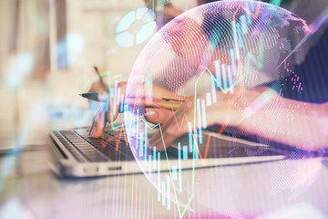 Multi exposure of woman hands typing on computer and financial graph hologram drawing. Stock market analysis concept.