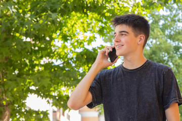 Fototapeta premium male teenager with mobile phone on the street