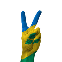 Hand making victory sign, Saint Vincent and the Grenadines painted with flag as symbol of victory,...