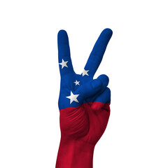 Hand making victory sign, samoa painted with flag as symbol of victory, win, success - isolated on...