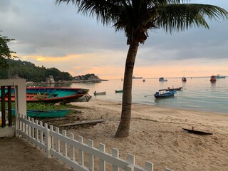 Backyard landscape view of boat beach coastline at sunset