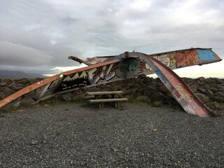 Graffiti covering iron artwork near picnic table