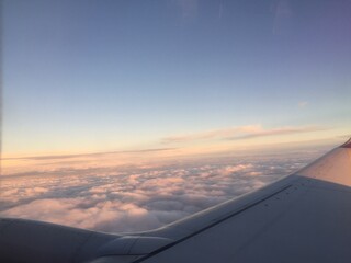 Fototapeta na wymiar Aerial view of sunset clouds from airplane window