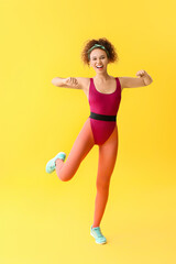 Fototapeta na wymiar Young woman doing aerobics on color background