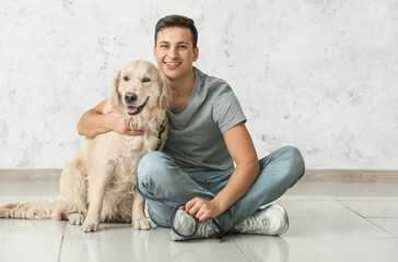 Young man with cute dog indoors