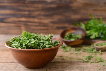 Bowl with dry parsley on table