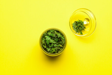 Jar with dry parsley on color background