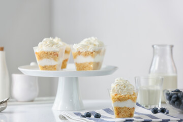 Delicious cupcakes in jars on table