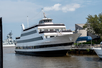 Fototapeta na wymiar Ferry boat in harbor of town, motor yacht on the blue ocean