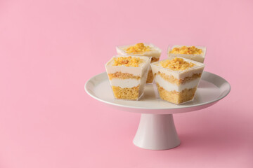 Delicious cupcakes in jars on color background