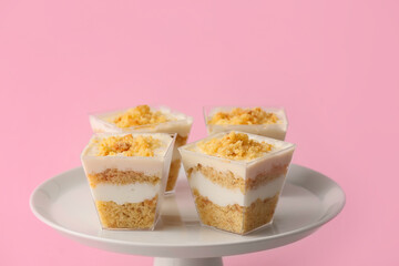 Delicious cupcakes in jars on color background