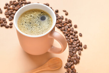 Cup of hot coffee and beans on color background