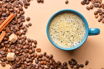 Cup of hot coffee and beans on color background