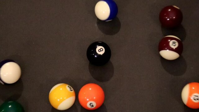 Billiard pool ball break, overhead in slow motion with eight ball resting in center