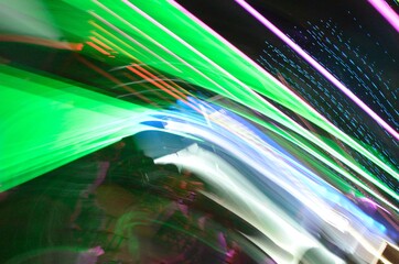 Long exposure photo of color LED and Neon lights with camera motion and dark background