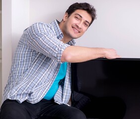 Young man watching tv at home