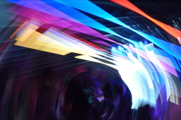 Long exposure photo of color LED and Neon lights with camera motion and dark background