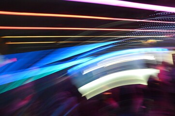 Long exposure photo of color LED and Neon lights with camera motion and dark background