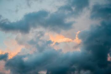 Fototapeta premium Stormy cloudscape with blue and orange hues
