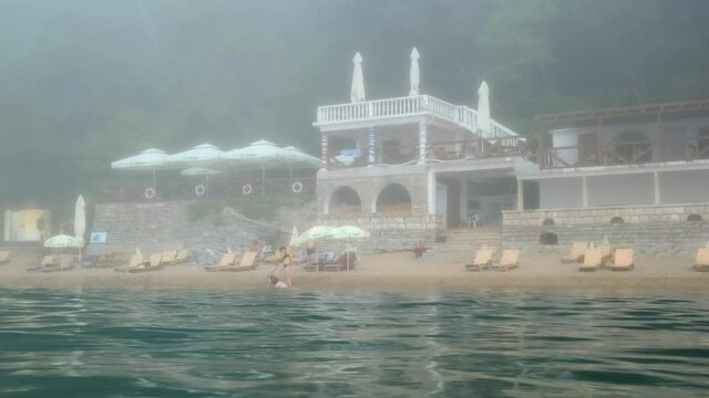 View from the sea to Mogren beach during fog, Budva, Adriatic Sea, Montenegro, Europe