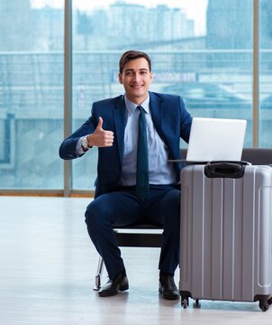 Businessman waiting at the airport for his plane in business cla