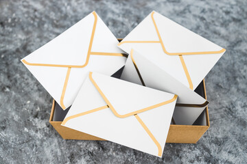 concept of inbox organisation, group of envelopes inside box metaphor of email inbox