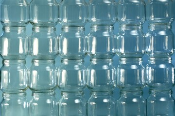 The background is from of transparent small cans, large fragment of a lined wall of cans placed on top of each other.