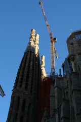 Architecture detail of the Sagrada Familia cathedral with crane, designed by Antoni Gaudi, in Barcelona, Spain