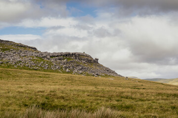 Glacial Erratics on Keld Head Scar with a view to Ingleborough Hill at sunrise, Kingsdale, Yorkshire Dales, North Yorkshire