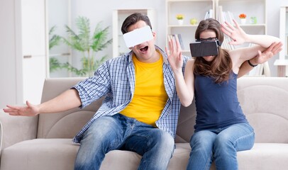 Young family playing games with virtual reality glasses