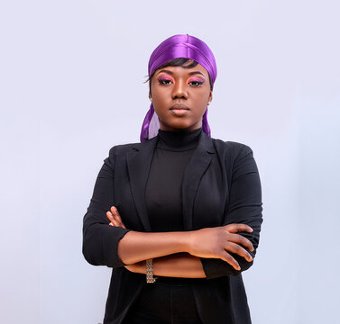 Smartly Dressed female model wearing a durag and looking at the camera