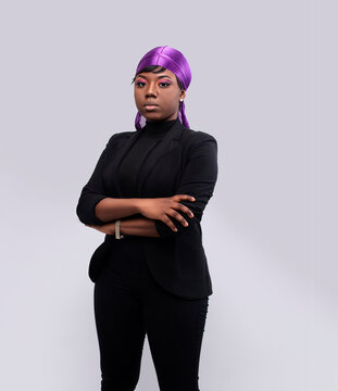 Smartly Dressed female model wearing a durag and looking at the camera