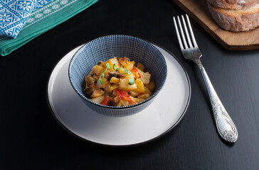 steamed veggies in white cup with blue pattrn on the black table