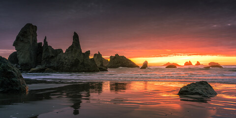 Fiery sunset over Castle Rock Formation at Bandon Beach in Oregon. 