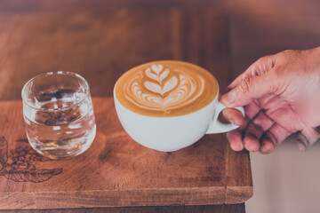 vintage a hot cappuchino coffee on wooden table