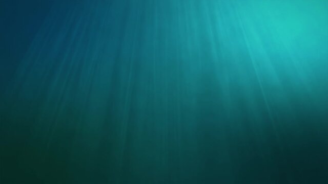 Underwater sun light beams shining from above coming through the deep clear blue water