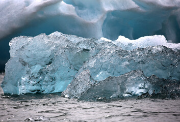 Closeup blue iceberg and volcanic ash at a glacial lagoon in Iceland