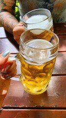 Man and woman toast each other with beer